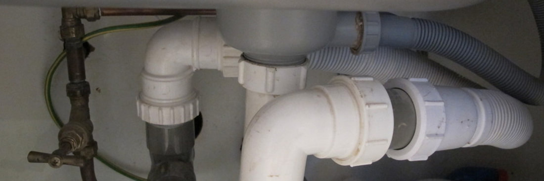 Arco central heating engineers and plumbers in Harold Wood. photo of the pipework under a kitchen sink