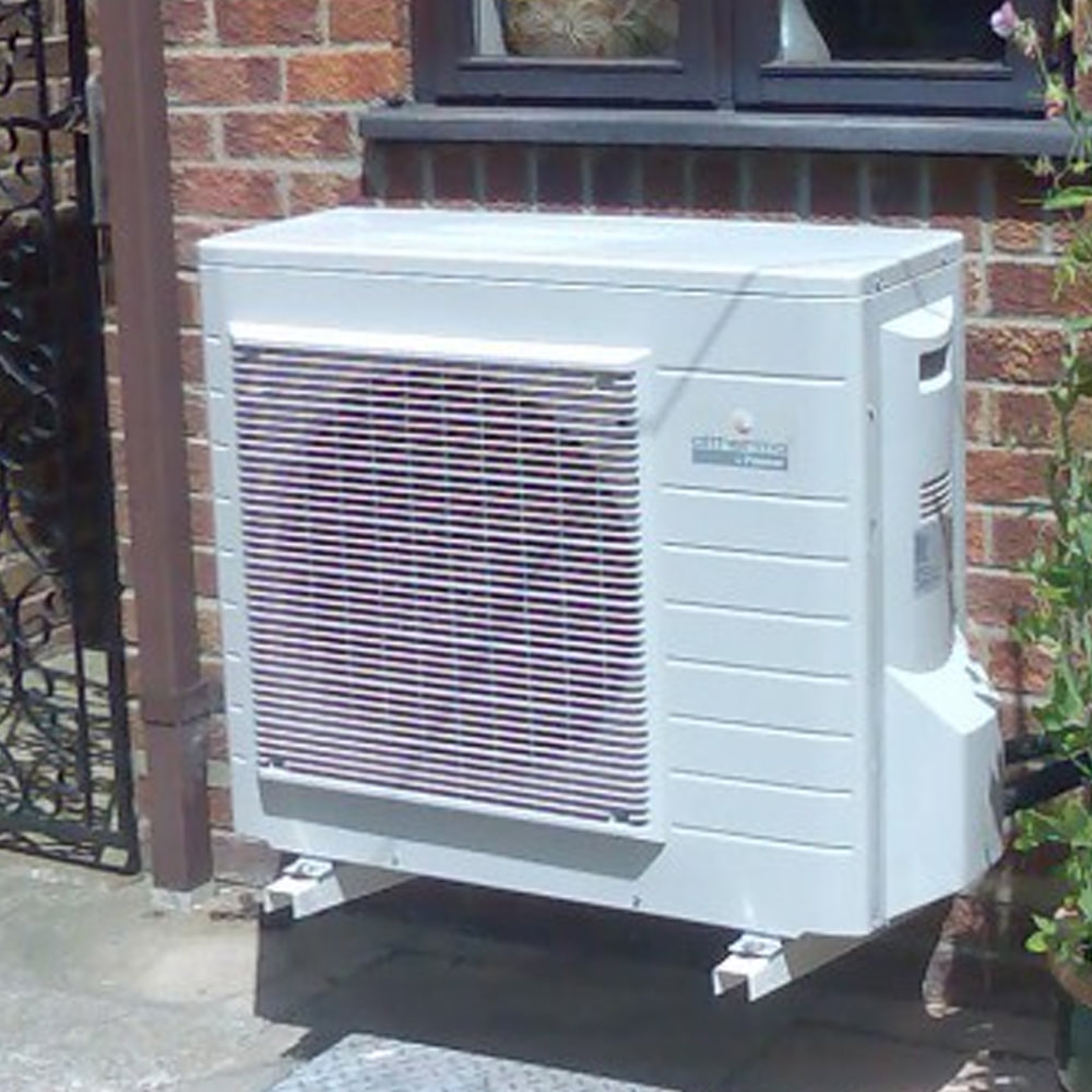 Arco install air pumps in Brentwood. Image of an air source heat pump attached to the wall of a house.