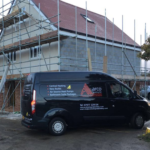 Arco new builds Romford. Photo of a house being built with a black Arco Heating Ltd van in the foreground.